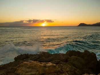 Scenic view of sea against sky during sunset