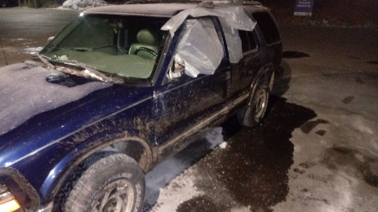 CLOSE-UP OF DAMAGED CAR ON ROAD