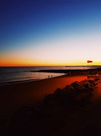 Scenic view of sea against clear sky during sunset