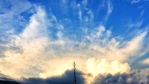 Low angle view of silhouette telephone pole against sky during sunset