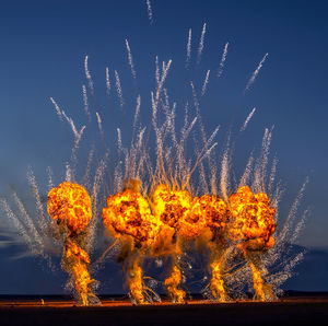 Firework display against clear sky at night