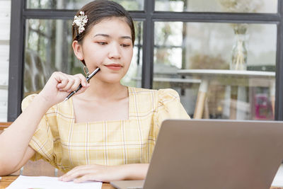 Beautiful asian business women contemplate ideas for new business projects.