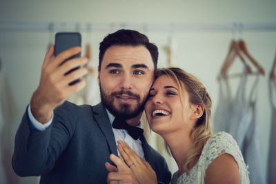 Portrait of smiling young man using mobile phone