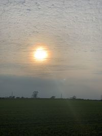Scenic view of field against sky during sunset