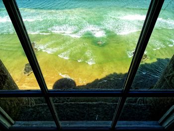 High angle view of sea seen through glass window