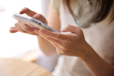 Midsection of woman using mobile phone