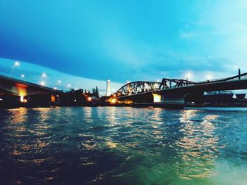 Low angle view of bridge over river at night