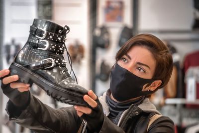 Portrait of young woman holding camera