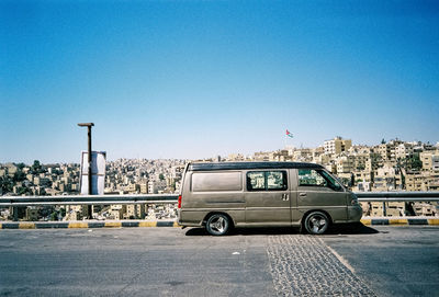 Vehicles parked on road against buildings