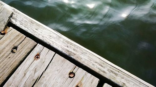 Close-up of wood against lake