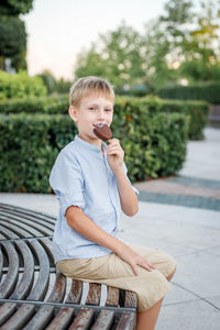 Portrait of boy sitting outdoors