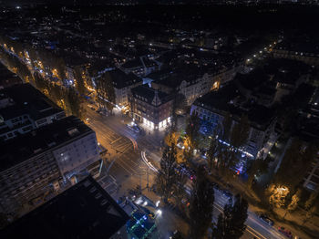 High angle view of illuminated city street and buildings at night