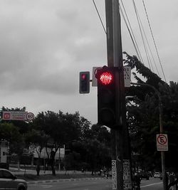 Low angle view of road sign against sky