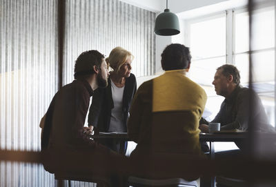 Creative business team discussing in board room at office