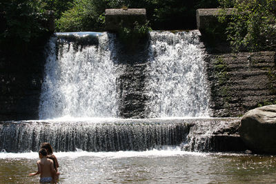 Blurred motion of man splashing water