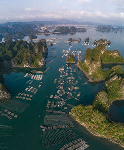 High angle view of sea and mountains against sky