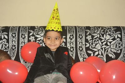 Portrait of boy on balloons