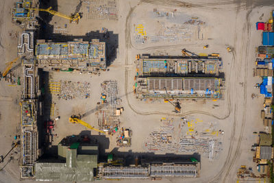 Aerial top view construction site with industrial consgruction machinery building for new factory 