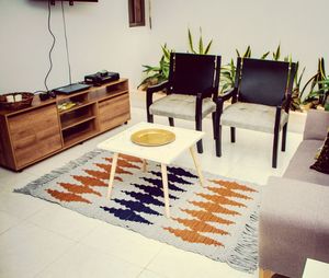 High angle view of chairs and table at home