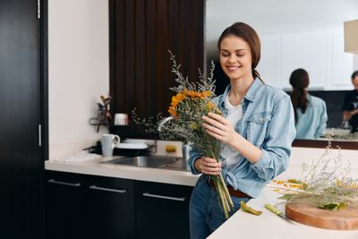 Portrait of young woman using mobile phone at home