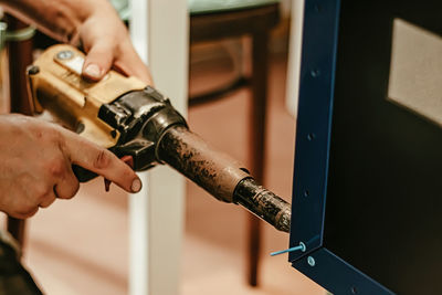 Cropped hand of man repairing car