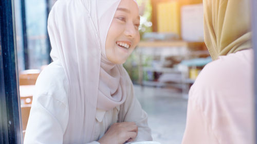 Side view of a smiling young woman