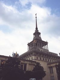 Low angle view of building against cloudy sky