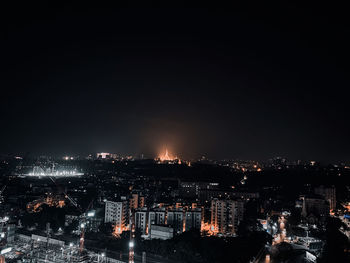 High angle view of illuminated cityscape against sky at night