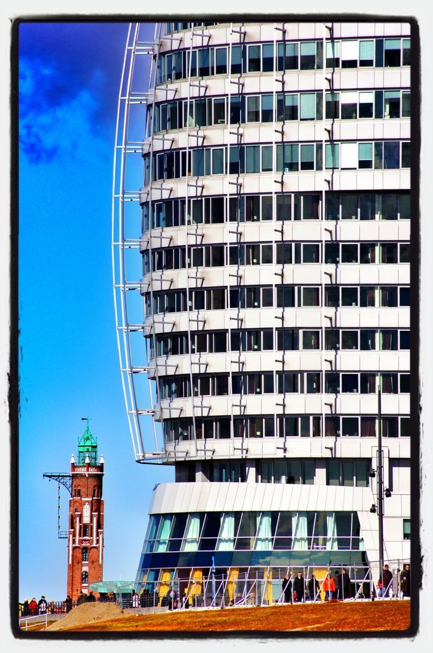 architecture, building exterior, built structure, low angle view, transfer print, city, building, window, modern, auto post production filter, office building, tower, glass - material, tall - high, day, skyscraper, sky, outdoors, blue, no people