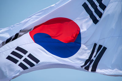 Low angle view of flag against sky