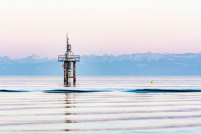 Sunset at lake constance in winter with alps