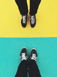 Low section of person standing on tiled floor