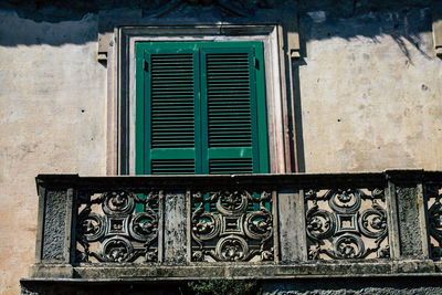 Close-up of closed window of old building