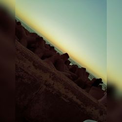 Close-up of rocks against clear sky during sunset