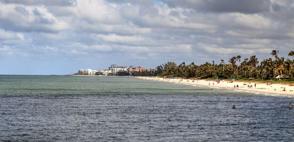 View of beach against cloudy sky