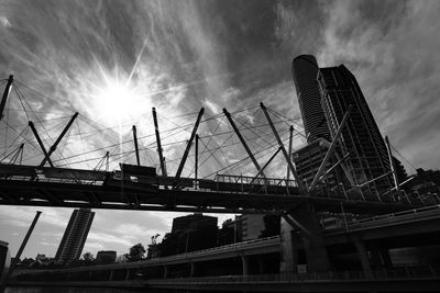 Low angle view of bridge against cloudy sky