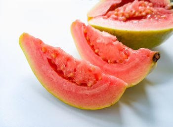 Close-up of sliced fruit against white background