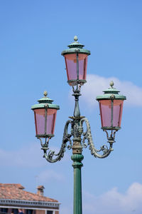 Low angle view of street light against building