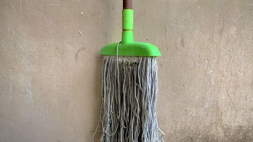 Close-up of mop against wall