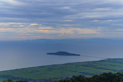 Scenic view of sea and mountains against sky