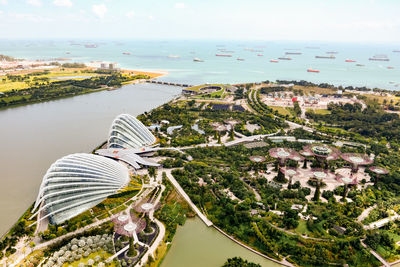 Aerial view of marina bay sands by sea against sky