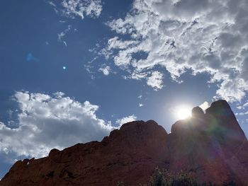 Low angle view of sun shining on mountain