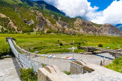 Scenic view of land and mountains against sky