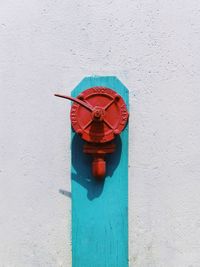 Close-up of fire hydrant against wall