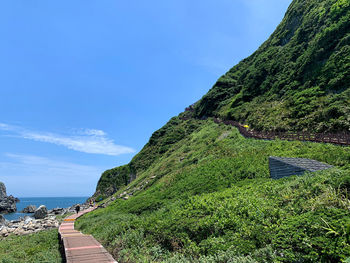 Scenic view of mountains against blue sky