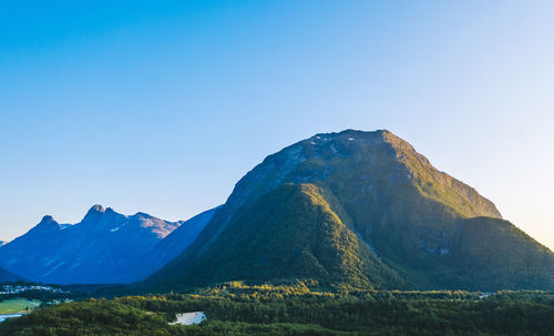 Scenic view of mountains against clear blue sky