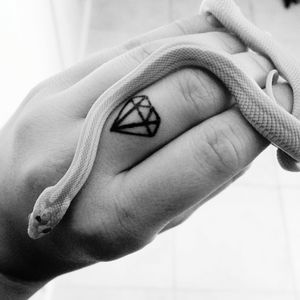 Close-up of woman hand with tattoo and snake