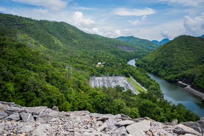 Scenic view of river amidst mountains against sky