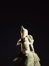 Low angle view of horse statue against sky at night