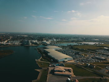 High angle view of buildings by sea against sky